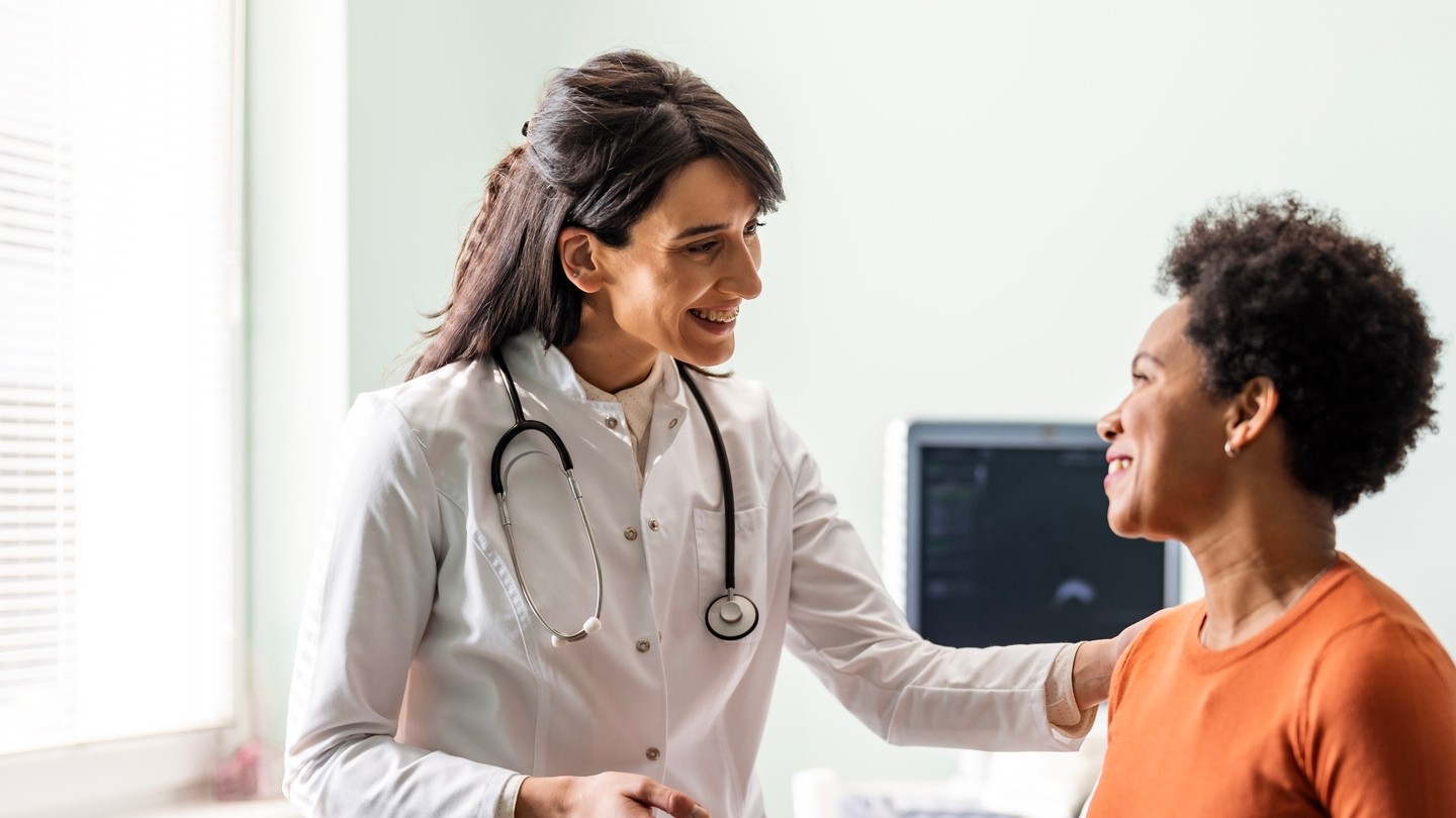 Female doctor talking to female patient