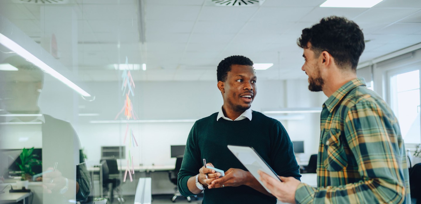 Two men talking in a professional office