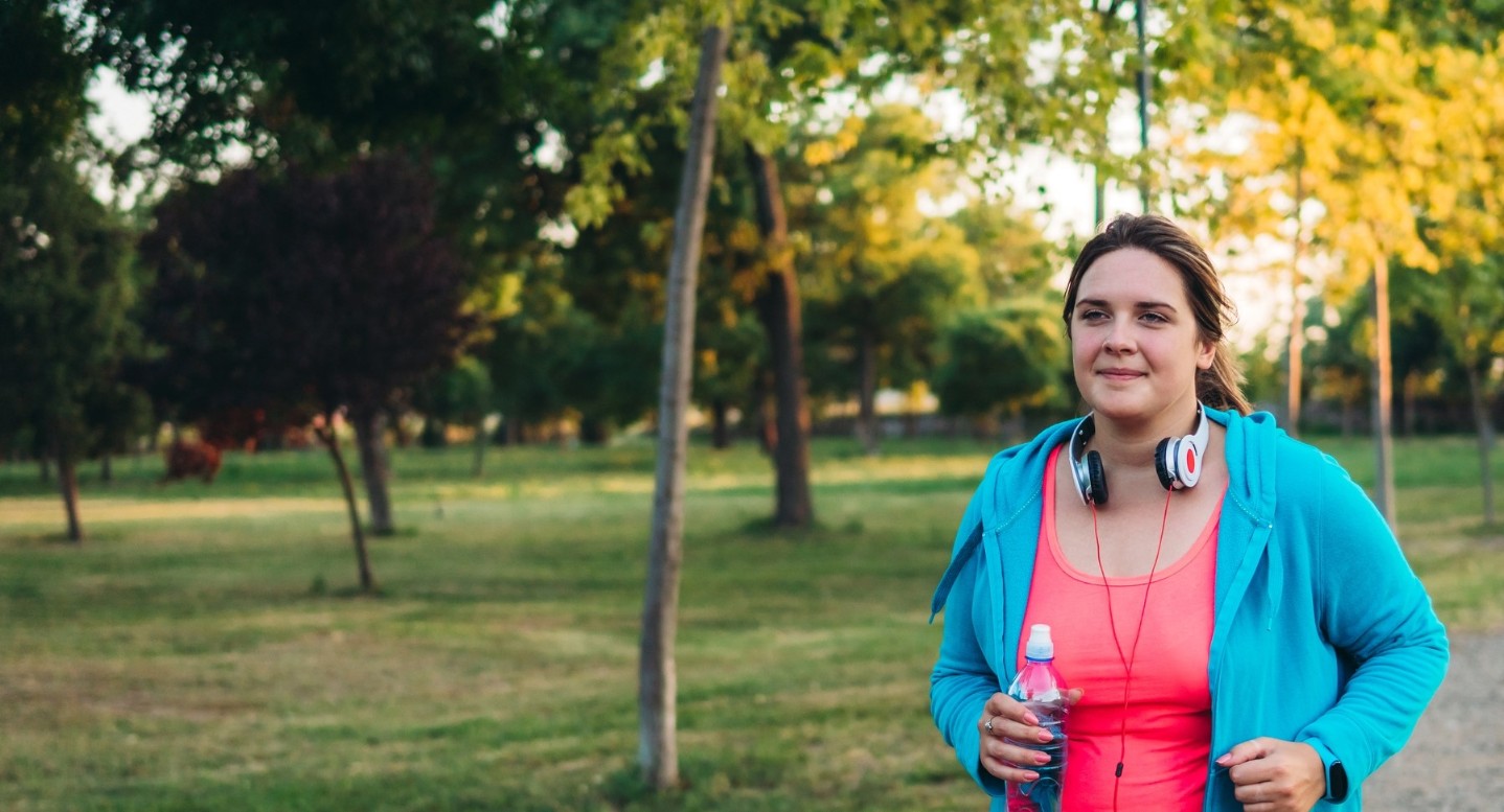 Young woman walking outdoors on a nature trail